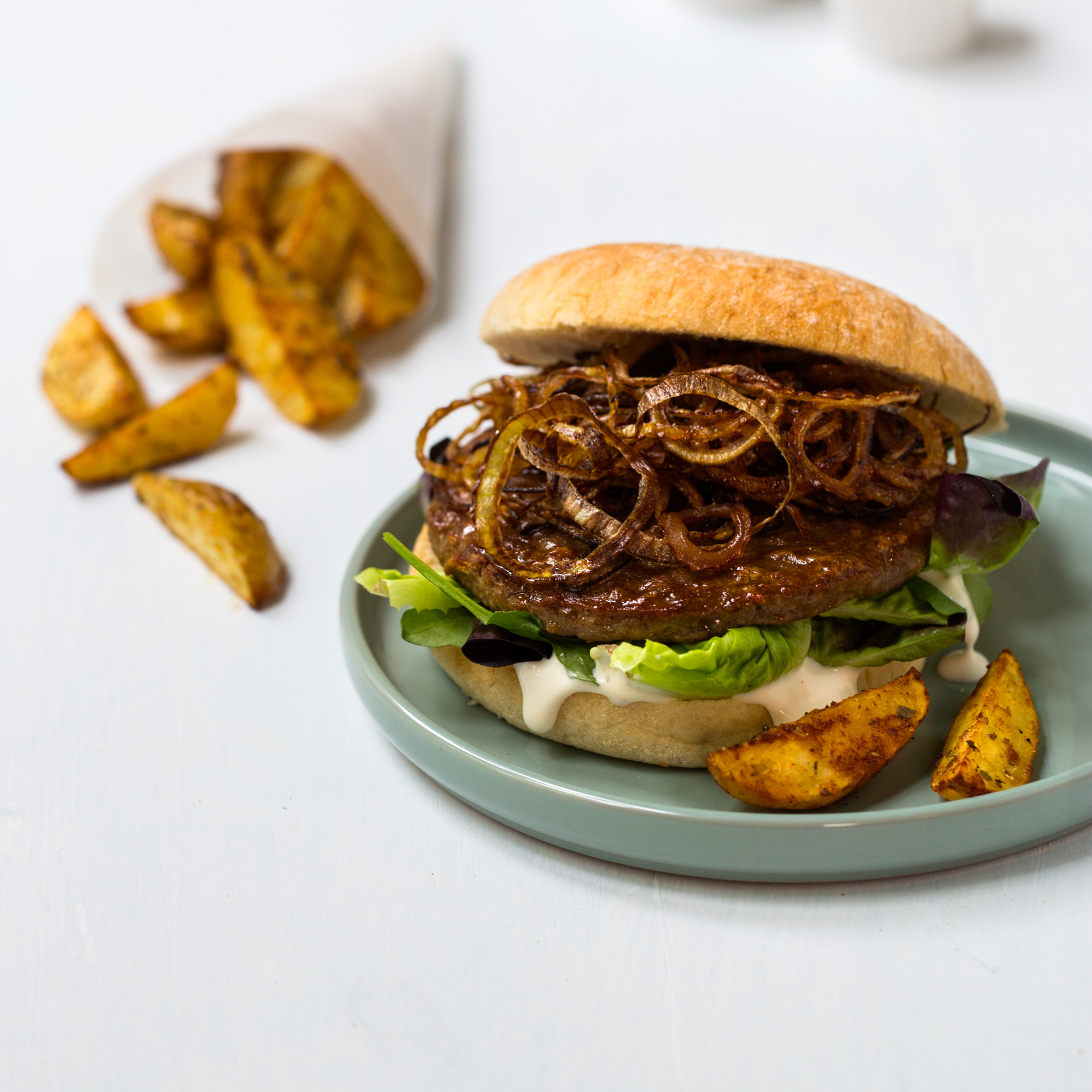 Burger med sprøstekt løk og stekte potetbåter