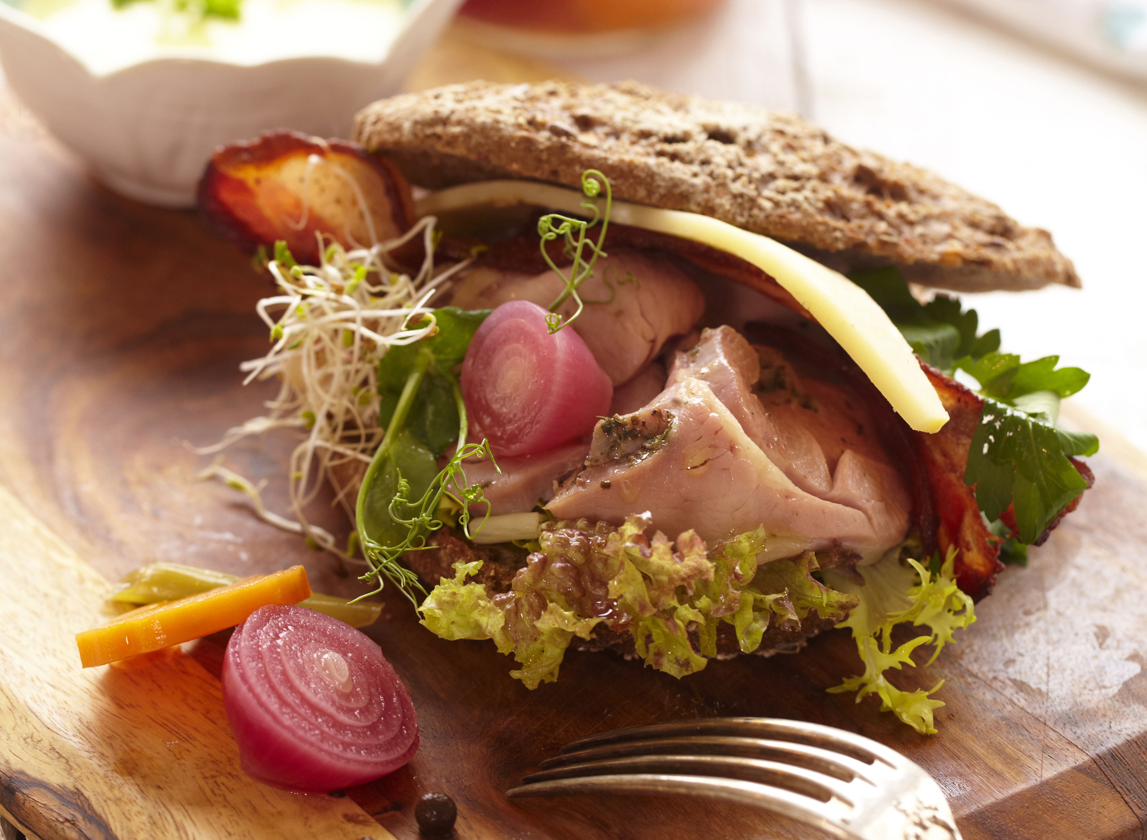 Kalkunsandwich med rugbrød, ost, bacon, pickles og ramsløkdressing